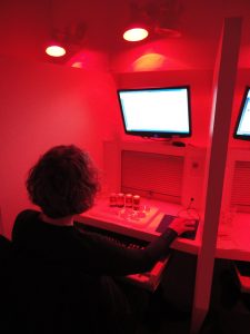 A trained sensory panelist evaluating apples in the sensory laboratory under red light to avoid visual bias.